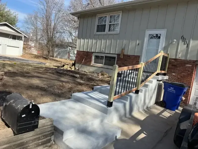 Accessible concrete walkway with handrail post footings in Kansas City