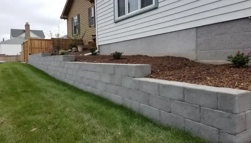 Retaining wall concrete pour with vibrator consolidation in Olathe