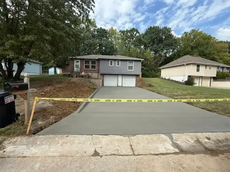 Two-car concrete driveway with flared apron connecting to Shawnee street
