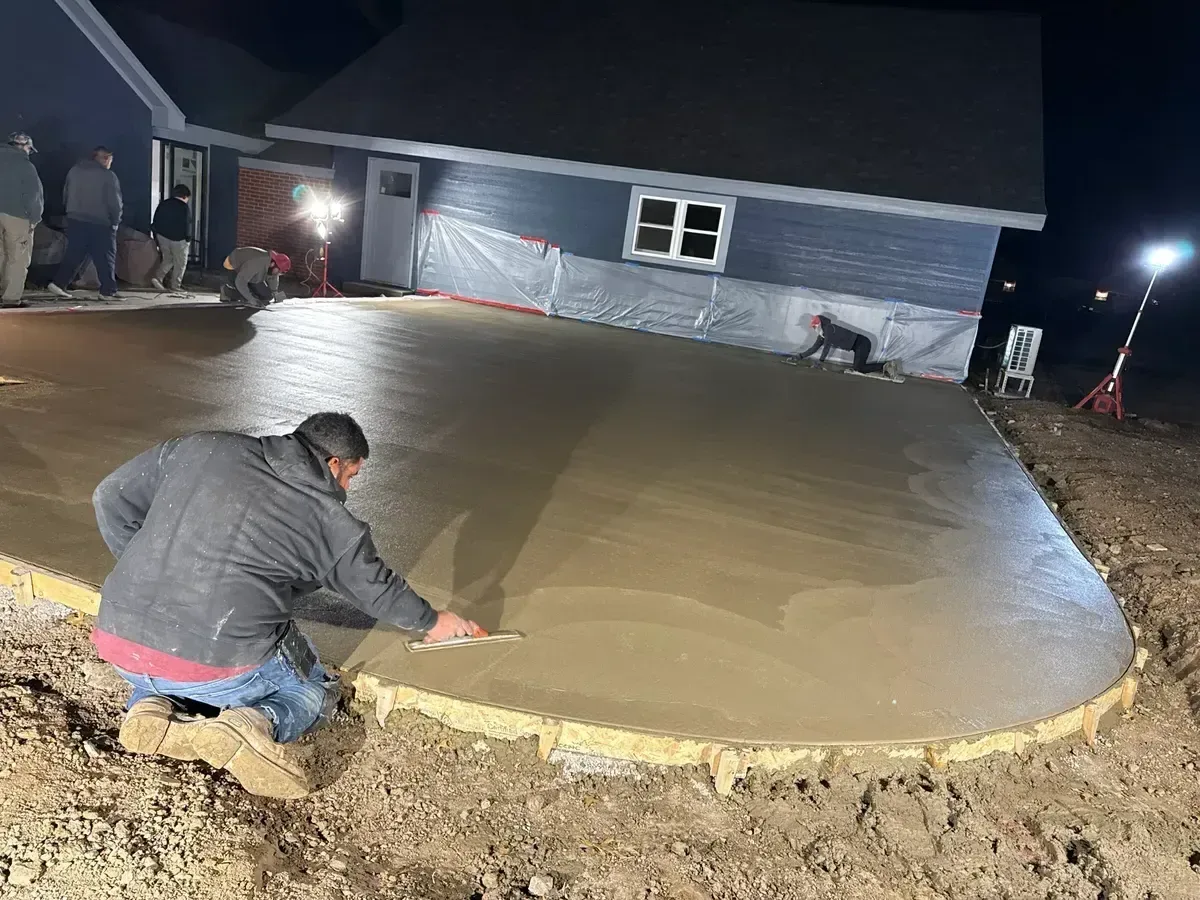 Kansas City concrete crew finishing a residential driveway pour with precision tools