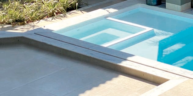 Fiberglass pool with integrated hydrotherapy spa in a Kansas City backyard